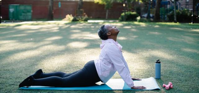 Elderly woman doing yoga in a park